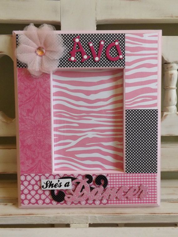 a pink and black photo frame with a flower on the top that says avc