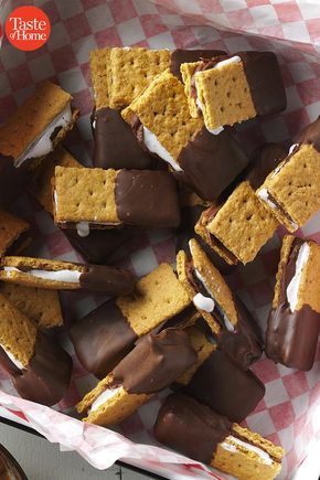 a basket filled with marshmallows and graham crackers on top of a table