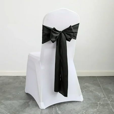 a white chair with a black bow on it