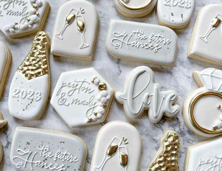 decorated cookies are arranged on a marble surface