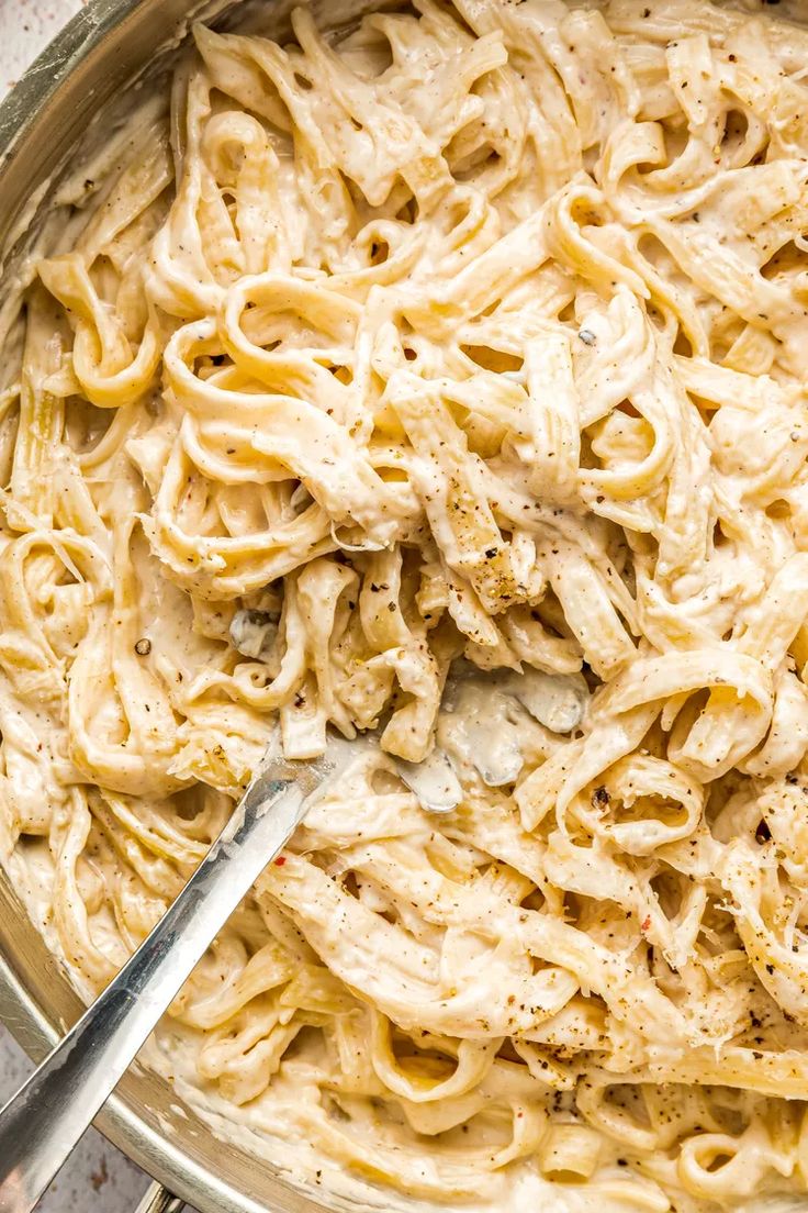 a large pot filled with pasta and chicken