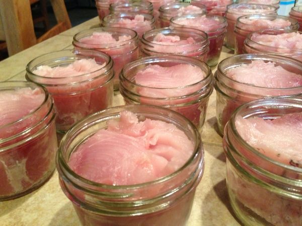 many jars filled with food sitting on top of a table