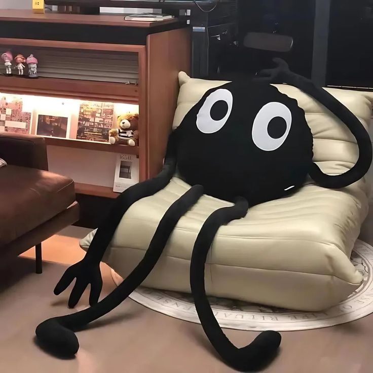 an octopus sitting on top of a couch in front of a tv set and chair