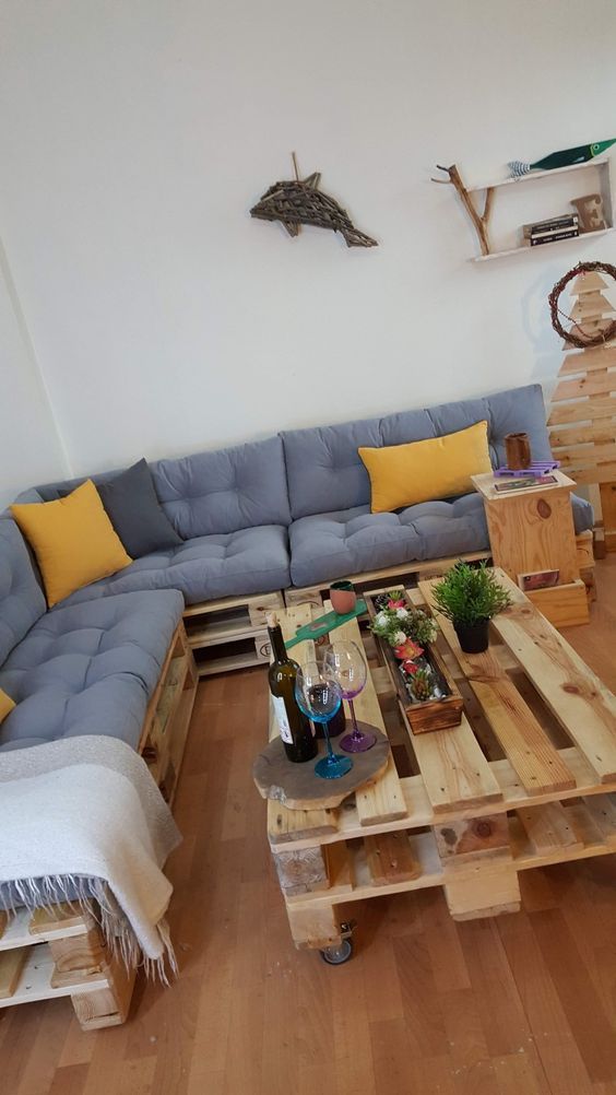 a living room filled with furniture and wooden pallets