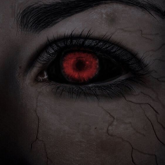 an evil looking person with red eyes