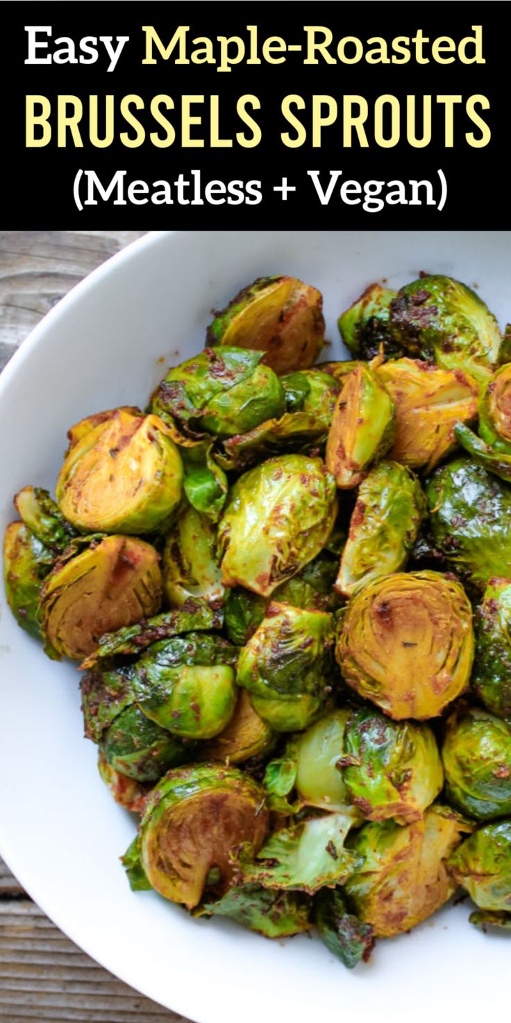 a white bowl filled with brussel sprouts on top of a wooden table