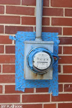 an electrical box attached to a brick wall