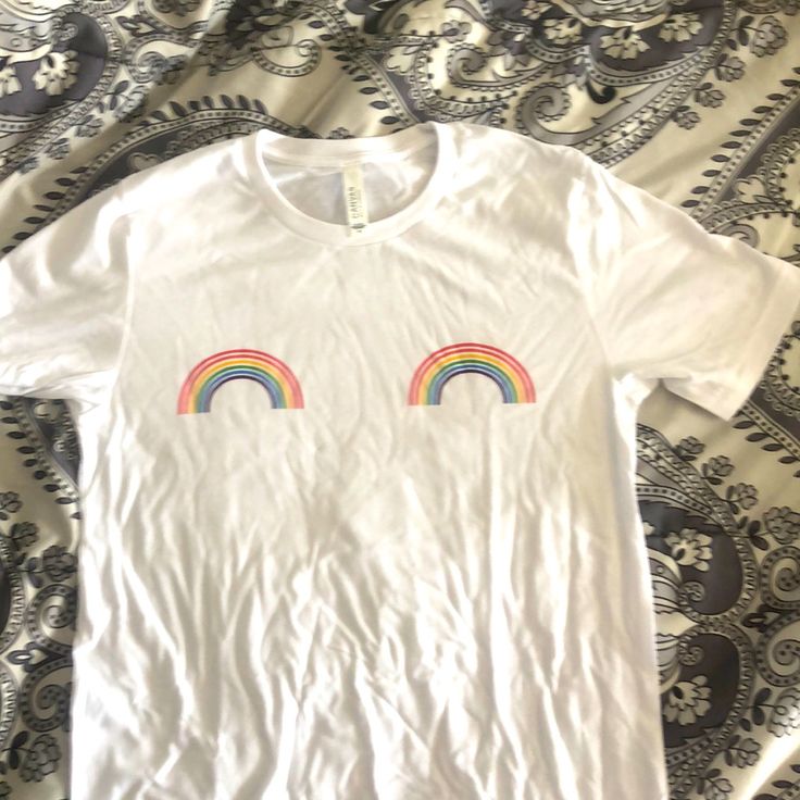 White Cotton Tshirt With Small Rainbows On Chest. Never Worn. Cotton T-shirt With Rainbow Print For Pride, Trendy Cotton T-shirt With Rainbow Print, Trendy Crew Neck T-shirt For Pride, Trendy Rainbow Top For Pride, White Screen Print T-shirt For Pride, Trendy Rainbow T-shirt For Spring, Pride Multicolor Short Sleeve Tops, Rainbow Graphic Print Top For Summer, Summer Rainbow Graphic Print Tops