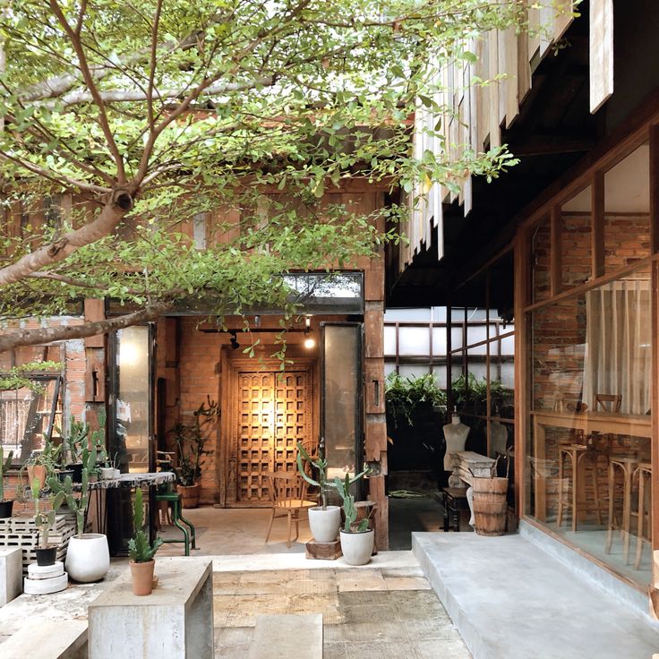 the entrance to a building with potted plants