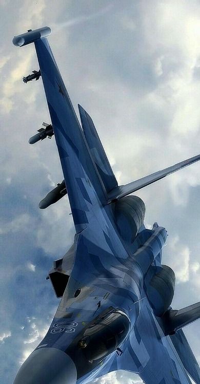 a fighter jet flying through the sky with clouds in the backgrounds