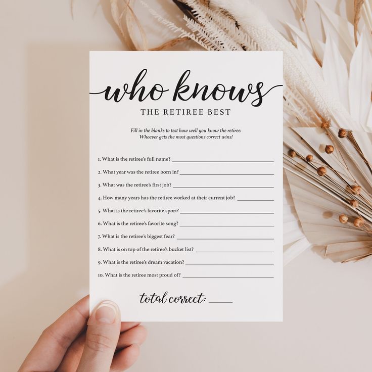 a person holding up a printable who knows the retirement best question card next to feathers