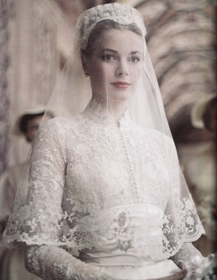 an old photo of a woman wearing a wedding dress and tiara with veil over her head