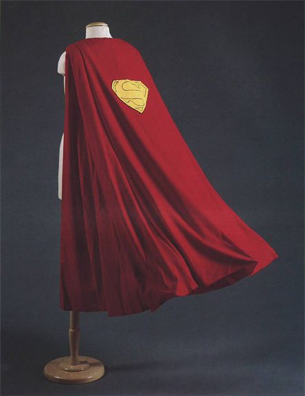 a mannequin wearing a red cape with a yellow superman symbol on it's chest