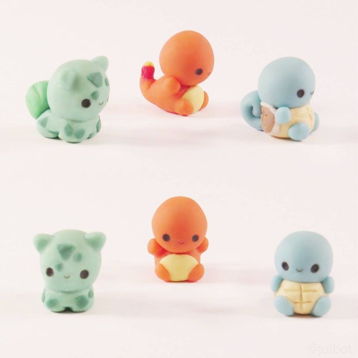 six small plastic animals sitting next to each other on a white surface with no background