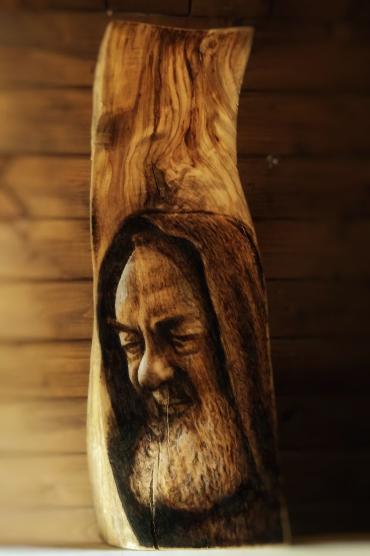 a wooden carving of a man with a beard