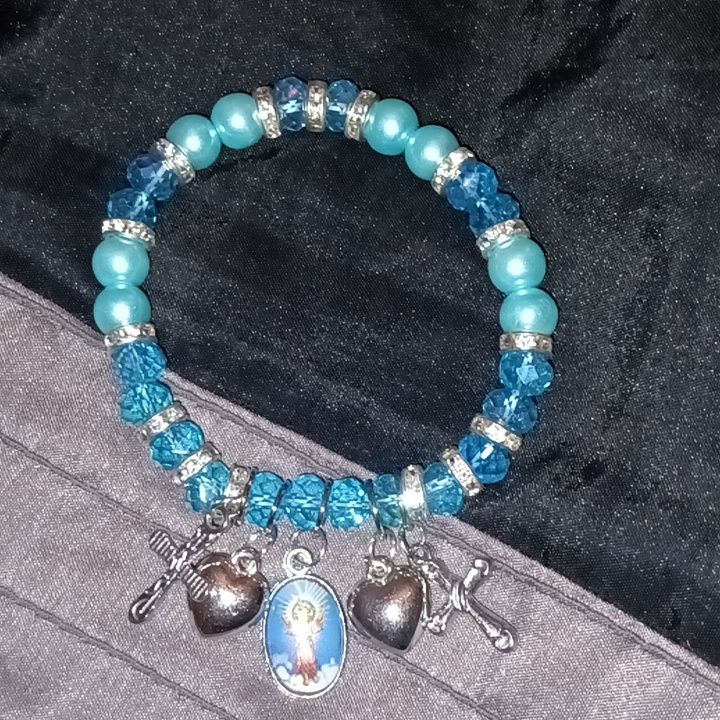 Baby Jesus Bracelet With Prayer Card In Baby Blue Beading Adjustable Blue Jewelry With Silver Beads, Blue Bracelets With Faceted Beads As A Gift, Nickel Free Blue Beaded Bracelets With Round Beads, Blue Faceted Beads Bracelet For Gift, Blue Bracelets With Faceted Beads For Gift, Blue Beaded Crystal Bracelet For Spiritual Use, Blue Stretch Bracelet With 8mm Beads For Jewelry Making, Blue Beaded Bracelets With Silver Beads, Blue Beaded Bracelets With 8mm Beads For Jewelry Making