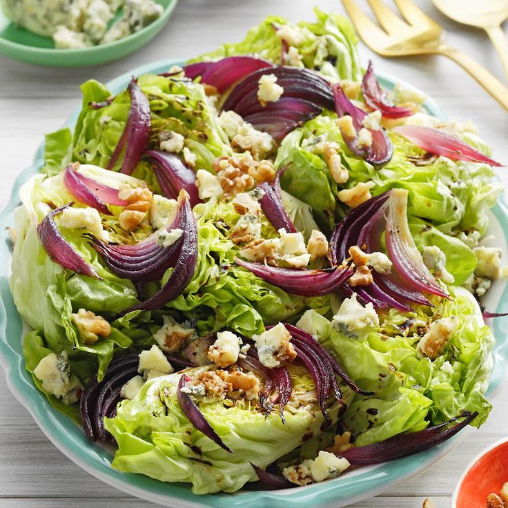 a salad with lettuce, radishes and walnuts on a plate