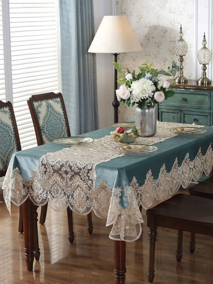 a dining room table covered in lace and flowers