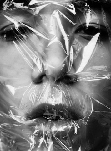 a woman with plastic wrapped around her face and nose is shown in black and white