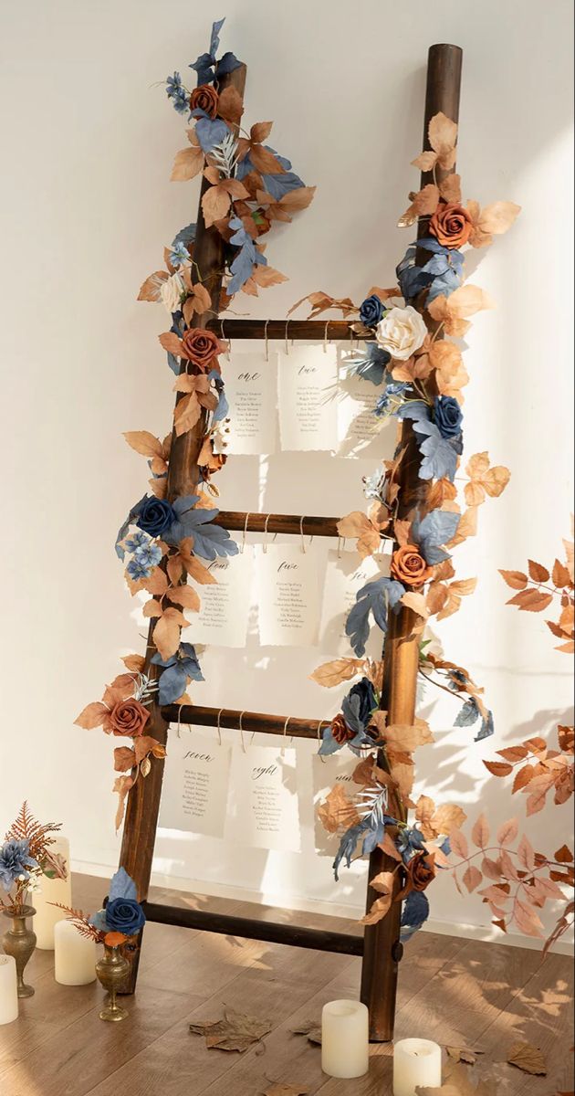 a ladder decorated with paper flowers and candles