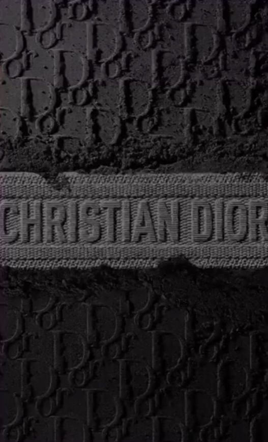 the word christian dore is written in black and white letters on a dark background