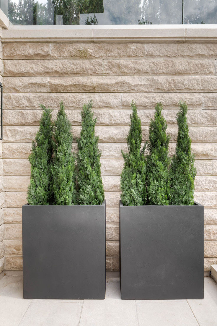 two black planters sitting next to each other