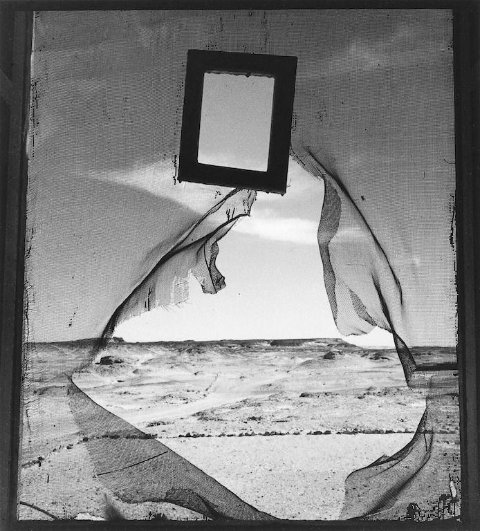 a black and white photo of the ocean with an empty square in it's center