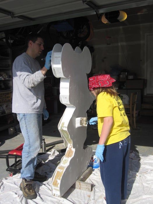 two people are working on a sculpture outside