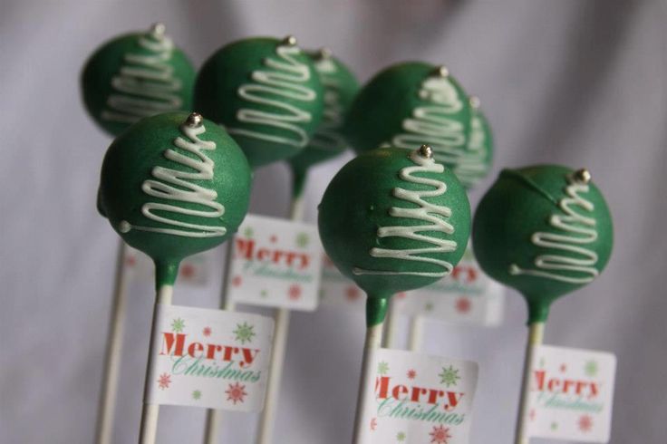 green christmas lollipops sitting on top of each other with merry written on them