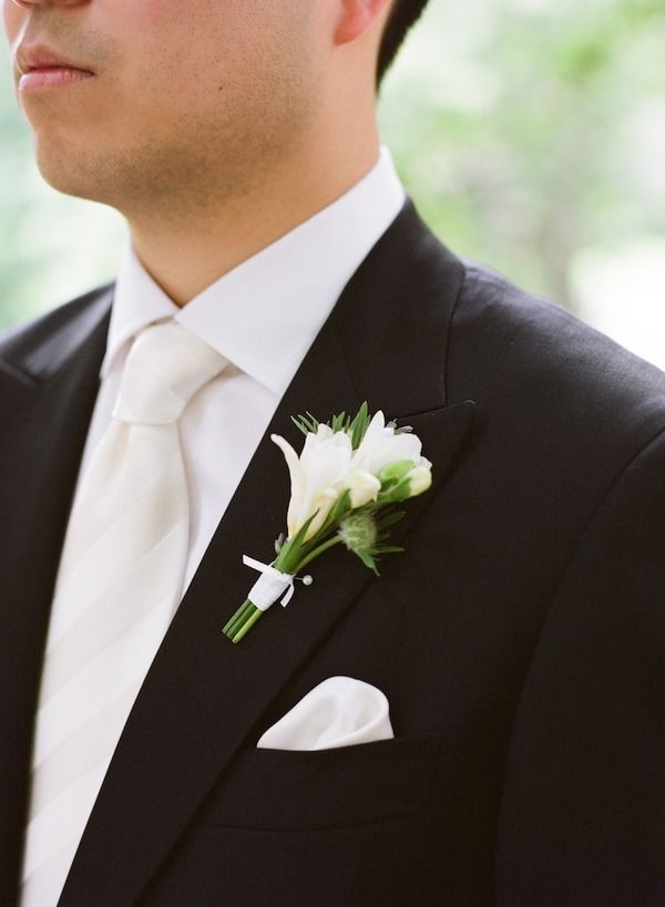 a man in a suit with a flower on his lapel