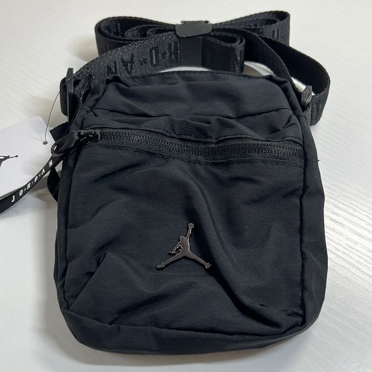 Nwt. Jordan Black Crossbody Sackpack Sporty Black Chest Backpack, Black Chest Bag With Mobile Phone Pocket For Streetwear, Sporty Black Shoulder Bag With Zipper Pocket, Black Chest Backpack With Cell Phone Pocket, Sporty Black Crossbody Shoulder Bag, Black Chest Bag For Streetwear With Phone Pocket, Black Nylon Bag With Zipper Pocket, Black Shoulder Bag With Zipper For Streetwear, Sporty Black Chest Bag For Daily Use