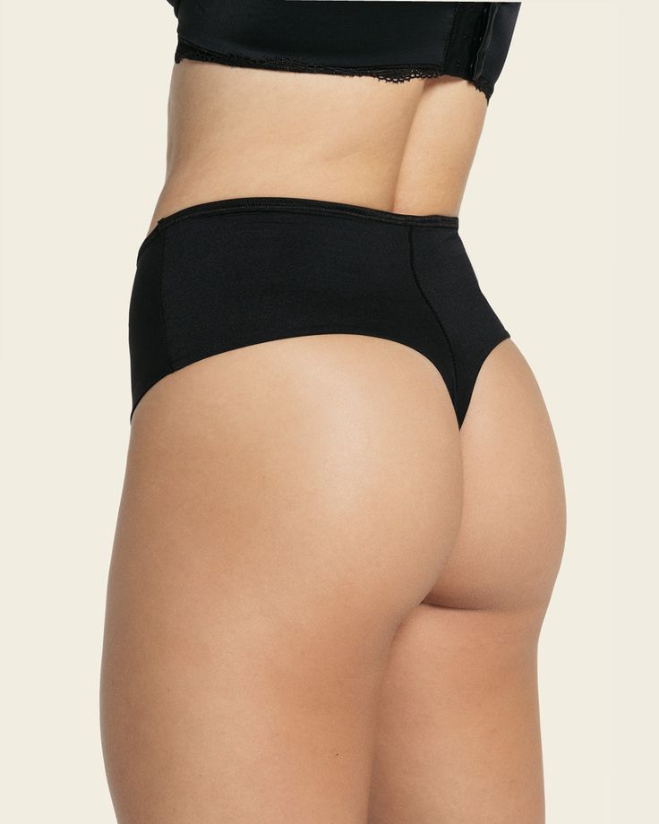 A high-waisted thong with luxurious satin details. An inner layer of PowerSlim® offers moderate compression to flatten the tummy and shape the waist. The thong bottom doesn't show under clothes, making this the perfect panty to wear under fitted pants, dresses, skirts, and more! Elegant High Cut Stretch Swimwear, Bra Friendly Full Coverage Elastane Shapewear, Elegant High-cut Leg Bottoms In Solid Color, Elegant Shaping Seamless Bottoms, High Waist Supportive Seamless Bottoms, Elegant Stretch Shapewear Bra Friendly, Classic Elastane Brief Bottoms, Compressive Full Coverage Bottoms With Smoothing Details, Elegant Compressive High Waist Shapewear