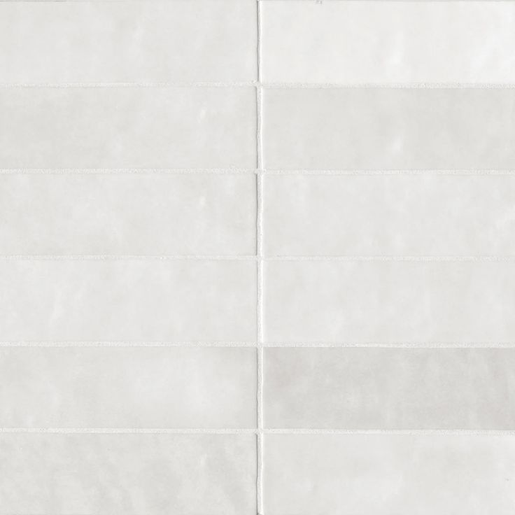 a white tiled wall with vertical lines on it