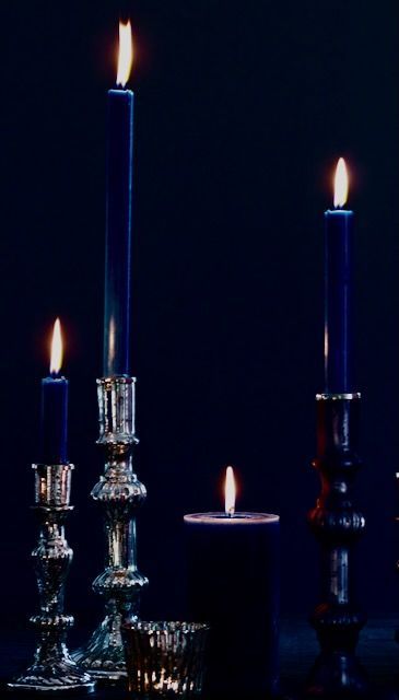 three lit candles sitting next to each other on a table