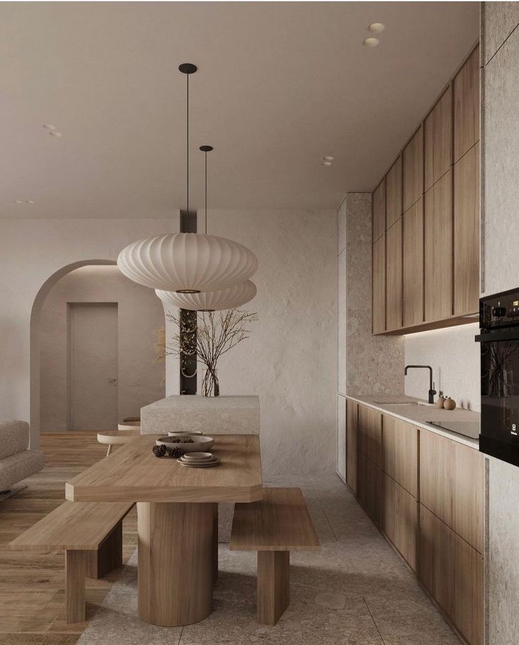 a modern kitchen with an oven, table and bench in the middle of the room