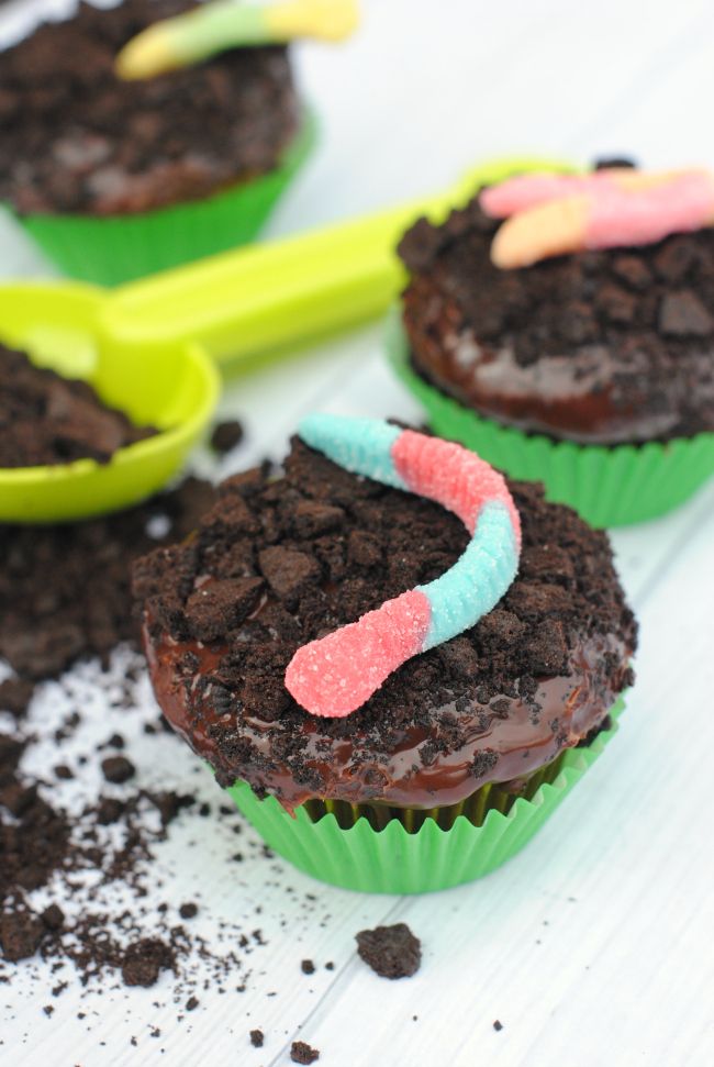 chocolate cupcakes with candy worms on them