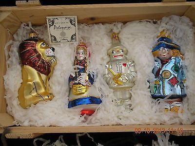 three glass figurines in a wooden box