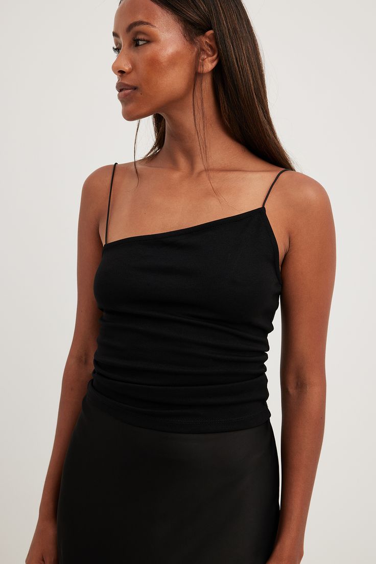 Black Second-skin Top For Party, Black One-shoulder Elastane Tops, Chic Seamless Camisole For Party, Sleek Spaghetti Strap Top For Night Out, Chic Elastane Tank Top With Spaghetti Straps, Sleek Cami Top For Party, Chic Tank Top With Spaghetti Straps, Seamless Fitted One Shoulder Top With Asymmetrical Neckline, Fitted Seamless One Shoulder Top With Asymmetrical Neckline