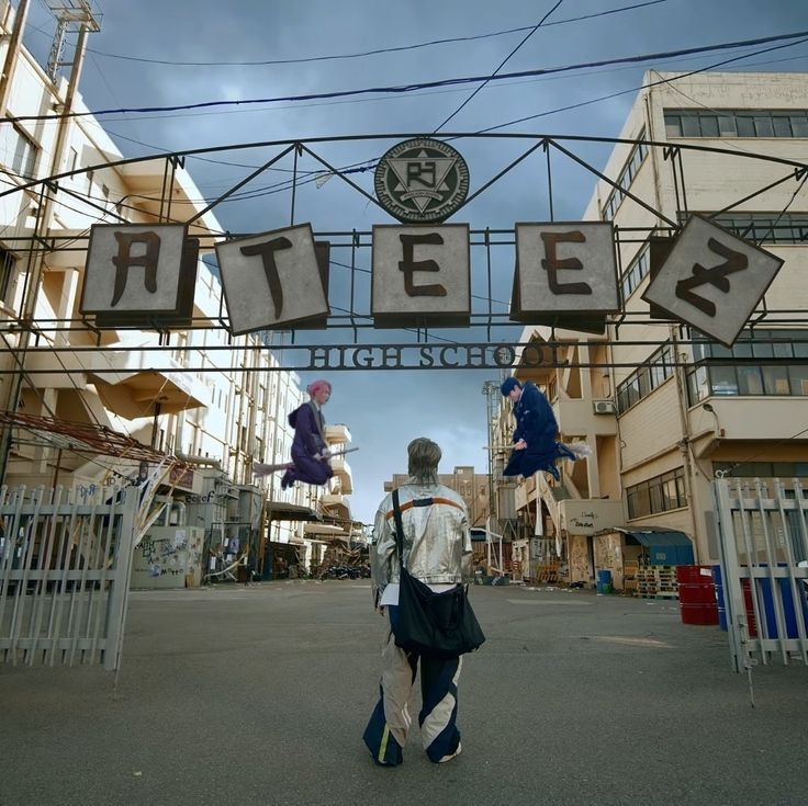 a person walking under a sign that says tater in front of some buildings on the street