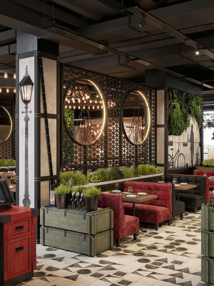 the interior of a restaurant with tables, chairs and planters on the side wall