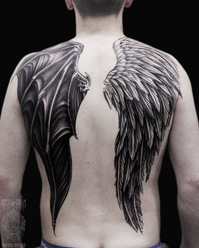 the back of a man with wings on his body and chest, showing it's black