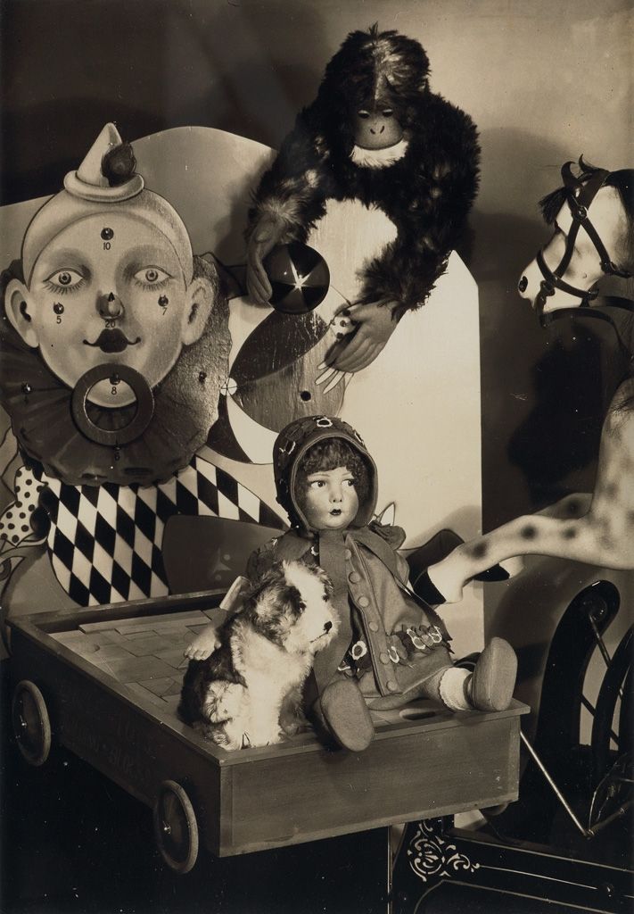 an old black and white photo with dolls