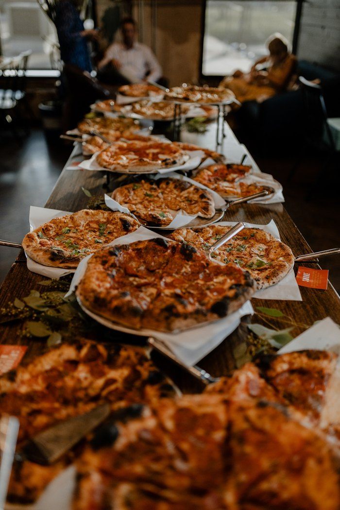 many plates of food are lined up on a long table