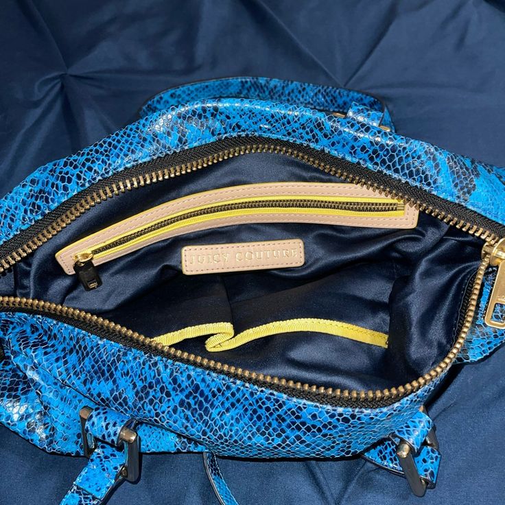 Juicy Couture Snake Print Bag. In The Color Blue With Hood Accents. Never Used, In Like New Condition. Shoulder Strap Top Zip Closure Interior Zip Pocket With 2 Slip Pockets Originally $248 Casual Blue Satchel With Zipper Closure, Blue Top Handle Shoulder Bag With Zipper Closure, Blue Pouch Satchel For Shopping, Blue Shoulder Bag With Zipper Closure And Top Handle, Trendy Blue Bag With Detachable Strap, Trendy Blue Bags With Detachable Strap, Trendy Blue Bag With Top Handle, Trendy Blue Top Handle Bag, Blue Pouch Shoulder Bag With Handles