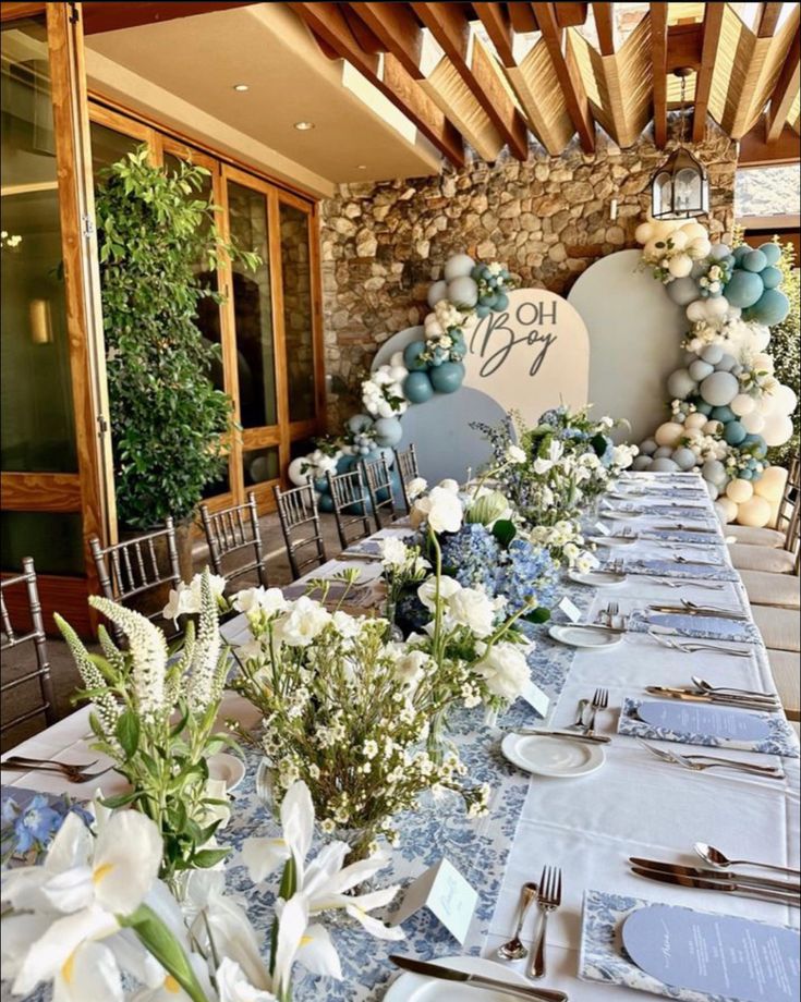 a table set up with flowers and place settings