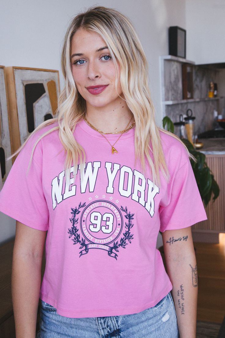 Show your love for the New York Athletic Department with this quirky pink graphic tee. Featuring a crew neckline and a cropped fit, this tee is perfect for a casual yet stylish look. Express your unique style with this eye-catching tee. General Info: 100% Cotton Hand Wash Cold; Dry Flat Crew Neckline Graphic Tee Cropped Fit Guide: Shape & Fit: Relaxed Fabric Elasticity: No Stretch Fabric Texture: Soft Model Info: Height: 5’6” | Bust: 34” | Waist: 25” | Hip: 34” | Size Shown: Small Pink Graphic Tee, Clothing Company, Fabric Texture, Crew Neckline, Stretch Fabric, Unique Style, Graphic Tee, Graphic Tees, Hand Wash