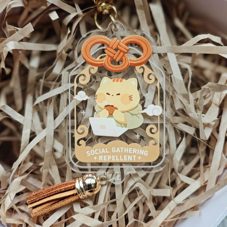 a keychain with an image of a cat on it sitting in a box