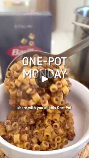 a bowl filled with macaroni and cheese sitting on top of a wooden table