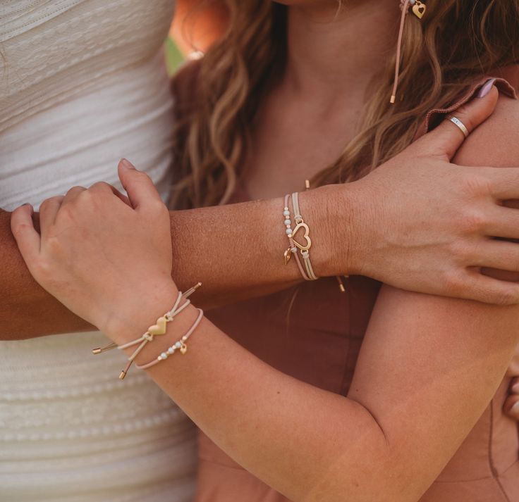 Introducing our "Mother/Daughter" set. This heartfelt bracelet hair tie set symbolizes the eternal bond between mother and daughter, with four heart charms expressing that the daughter's heart came from and is forever connected to her mother's. Whether worn in the hair or on the wrist they are adjustable to fit any size so that mother and daughter can share. Please allow 5-8 business days for shipping. Heart Bracelet For Friendship And Mother's Day, Mother's Day Friendship Heart Bracelet, Adjustable Heart Bracelet For Weddings, Valentine's Day Beaded Bracelets For Friendship, Adjustable Heart Bracelet For Wedding, Mother's Day Friendship Beaded Bracelet With Heart Charm, Rose Gold Charm Bracelet For Friendship, Adjustable Charm Bracelet For Mother's Day, Adjustable Heart Bracelet For Friendship