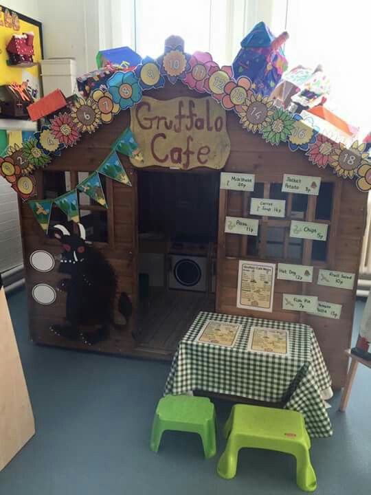 a child's play house made out of wooden pallets with tables and chairs